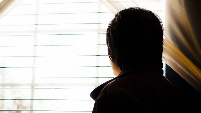 guy looking from window